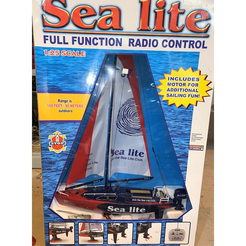 385 - An originally boxed 'Sea Lite' radio controlled yacht and 2 x 1970's vintage boxed games