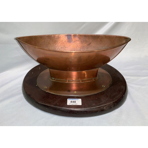 448 - An Arts & Crafts boat shaped copper vessel mounted on oval mahogany plinth