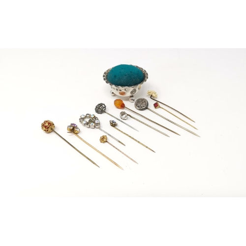 295 - A hall marked silver pin cushion and a selection of stick pins