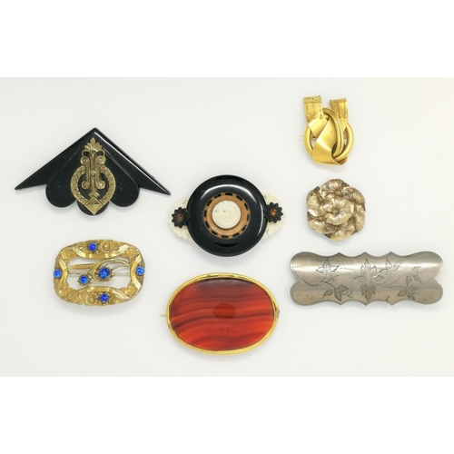 307 - A 19th century brooch set oval banded cornelian in gilt metal mount, 7 cm; 6 other brooches