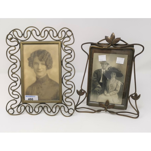 466 - An Edwardian Art Nouveau easel photo frame in brass, 22 cm; and another 25 cm