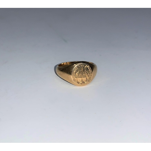 276 - A monogrammed signet ring with internal inscription, unmarked, tests as 18 ct, 5.5 gm