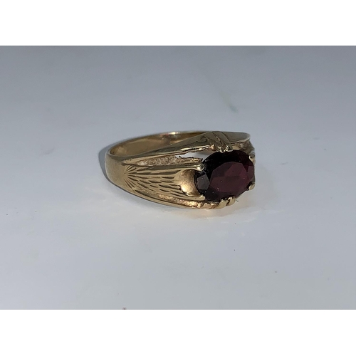 325 - A gent's 9 carat hallmarked gold signet ring, set garnet, 52 gm