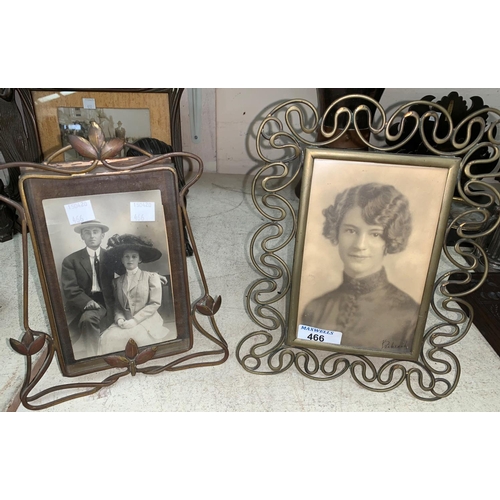 466 - An Edwardian Art Nouveau easel photo frame in brass, 22 cm; and another 25 cm