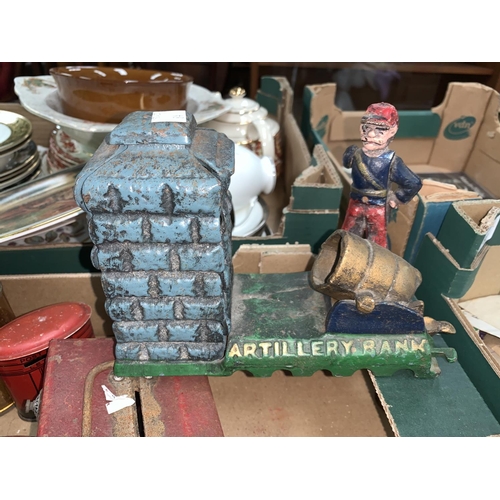 84 - A selection of novelty money boxes including a cast iron 'Artillery Bank' example