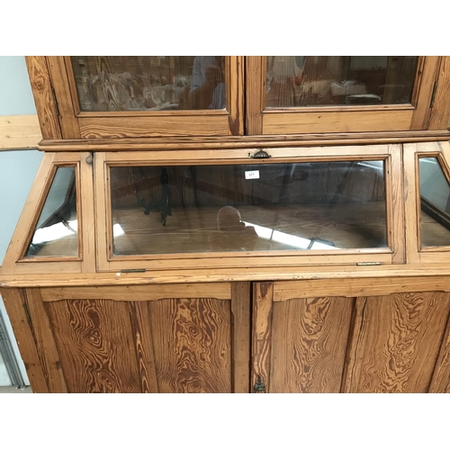 577 - A 19th century pitch pine museum display cabinet, full height, with 2 glazed doors and fall front di... 
