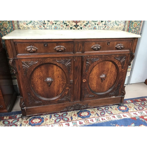 582 - A 19th century continental carved oak cabinet with marble top, 2 frieze drawers and double cupboard,... 