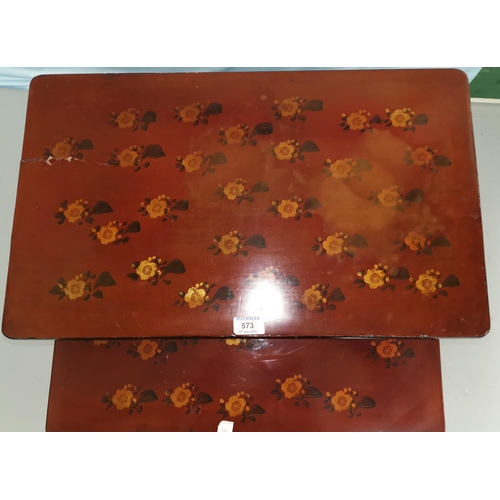 573 - A nest of red lacquered occasional table with rectangular tops