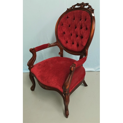 575 - A Victorian mahogany framed armchair, the oval back with carved crest, knurled arms and legs, uphols... 