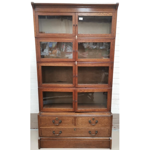 603 - An early 20th century inlaid oak sectional bookcase, 4 height, with 2 short and 1 long drawers below... 