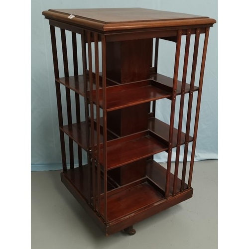 604 - An Edwardian 3 height revolving bookcase in stained wood, height 111 cm
