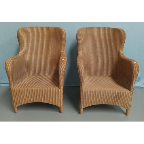 606 - A modern pair of woven cane armchairs
