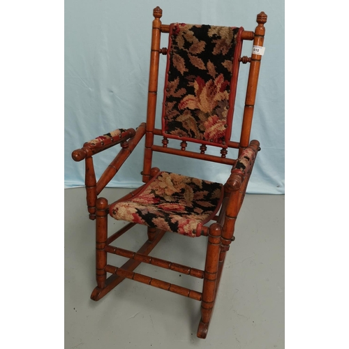 610 - A child's stained wood American rocking chair