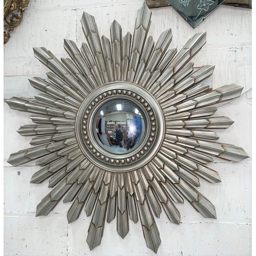 566 - A convex wall mirror in silvered sunburst frame