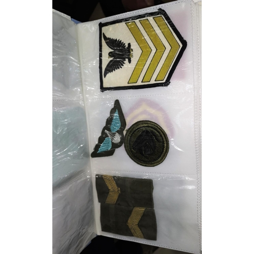 115 - A selection of military and other cloth badges and a selection of stamps in albums