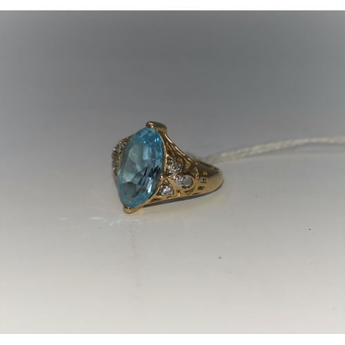 268B - A yellow metal dress ring stamped '375' set with marquise cut pale blue stone with 3 small diamonds ... 