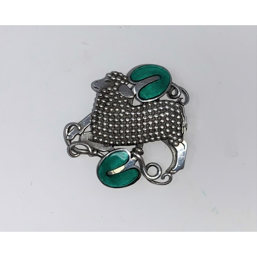 269a - Georg Jensen, an unusual Danish silver and enamel pierced brooch, a lamb with green enamel leaves ab... 