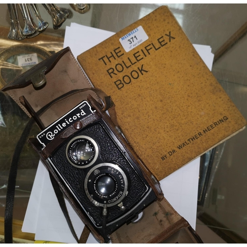 371 - A Rolleicord TLR camera in leather case, with handbook