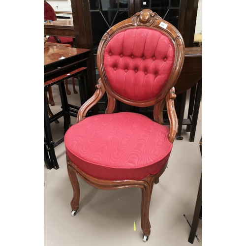 595 - A Victorian walnut nursing chair in buttoned burgundy