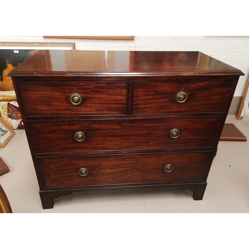 595a - A 19th century mahogany chest of 2 long and 2 short drawers with brass ring handles, on bracket feet... 