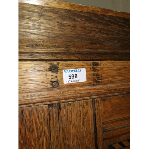 598 - An early 20th century oak wardrobe enclosed by 2 doors with marquetry inlay and arched panelling, wi... 