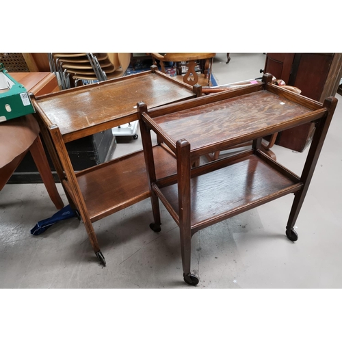 672 - A 1920's beaded mahogany oval top Sutherland table; 2 oak 2-tier tea trolleys