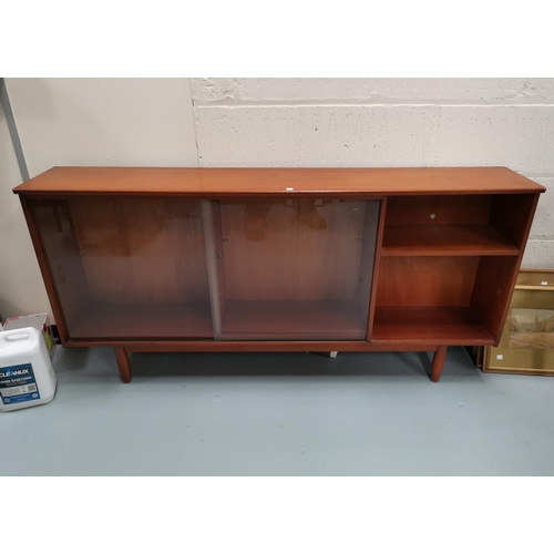 687 - A 1960's teak sidecabinet with open shelves and sliding glass doors; a 1960's 4 height chest of draw... 