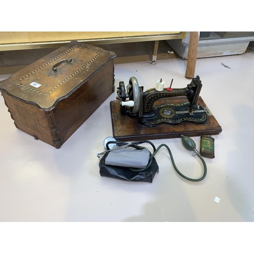 399 - A Victorian Jones hand operated sewing machine in inlaid case; a vintage blood pressure set