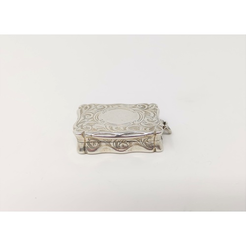 315 - A Victorian silver shaped rectangular vinaigrette with chased decoration, pierced gilded internal gr... 