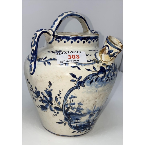 303 - An 18th / 19th century Delftware tin glazed jug with handle and spout decorated in blue and white wi... 