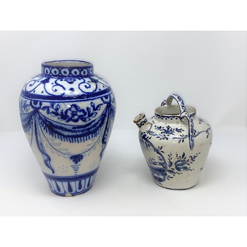 303 - An 18th / 19th century Delftware tin glazed jug with handle and spout decorated in blue and white wi... 