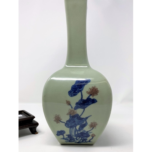 307A - A Chinese Celadon glazed square vase with bird and floral decoration etc, mark to base, on damaged s... 