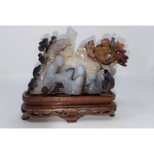 311 - A Chinese agate coloured stone carving of 2 people playing a board game, on base (not matching)(some... 