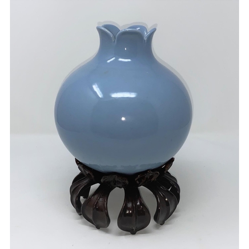 362 - A Chinese blue glaze vase in the form of a pomegranate with mark to base, hardwood stand (some damag... 