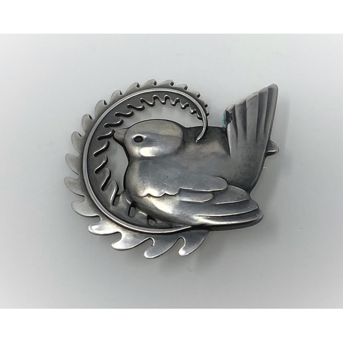 401 - A Georg Jensen silver brooch, wren perched on fern frond, name impressed in beaded circle, stamped 9... 