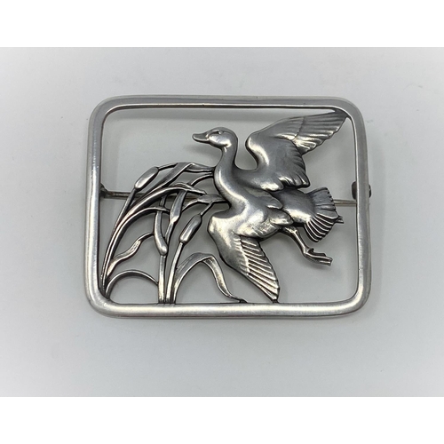 402 - A Georg Jensen silver brooch, pierced rounded rectangular shape, a duck flying past bulrushes, name ... 