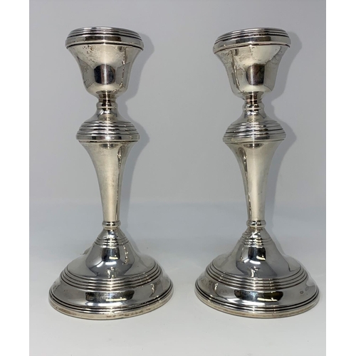 372 - A pair of silver candlesticks with turned decoration (weighted), Birmingham, 1971