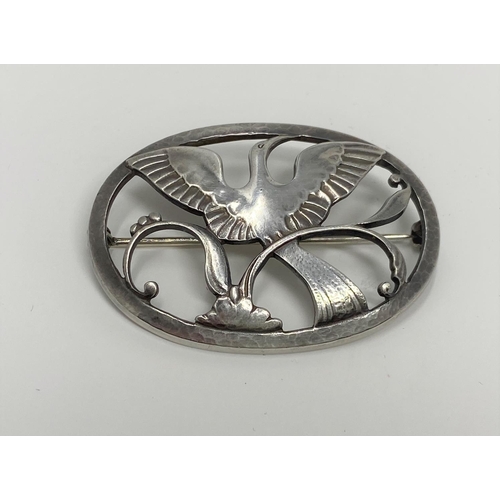 420 - A Georg Jensen silver brooch stamp 925s Denmark, number 238 featuring Bird of Paradise on branch, in... 