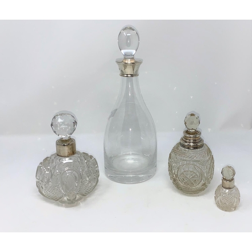 433 - A mallet shaped decanter with silver rim; 3 cut glass scent bottles with hallmarked silver collars