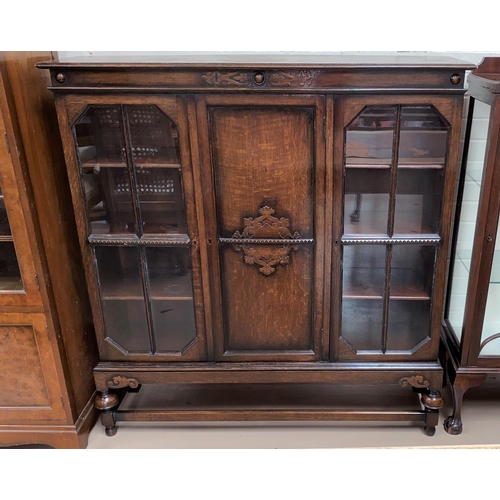 662 - A 1930's oak display cabinet with 2 glazed and panelled doors