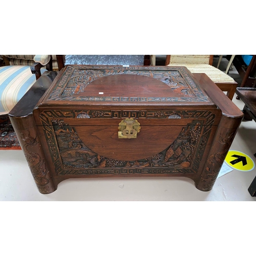 331 - A mid 20th century camphorwood chest with carved decoration