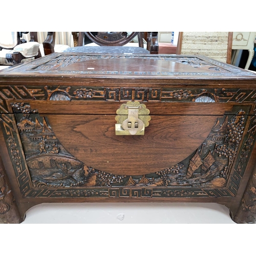 331 - A mid 20th century camphorwood chest with carved decoration