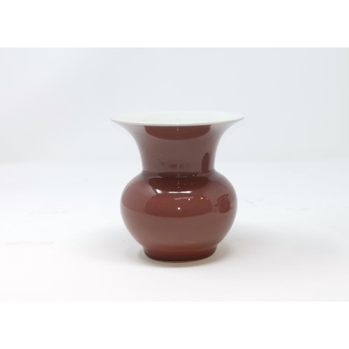 311a - A Chinese pale red 'spitoon' vase with flared rim, height 11cm