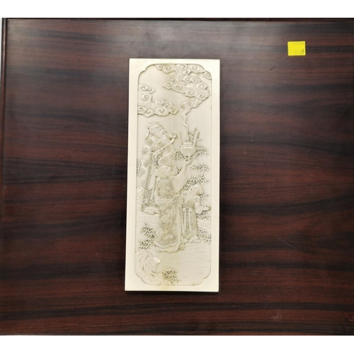 317A - A 19th century detailed carved ivory plaque of people releasing incense, mounted on hard wood panel ... 