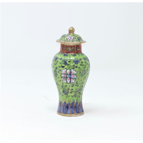 318A - A Chinese famille vert small clobbered lidded vase, decorated with floral decoration height 11.5cm