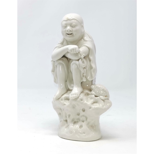 321 - A Chinese blanc de chine figure of seated man watched by a frog, (some hairline cracking) height 19c... 