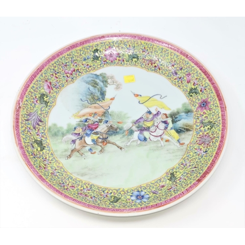 321C - A Chinese famille jaune wall plaque depicting central scene of warriors on horse back 34cm diameter