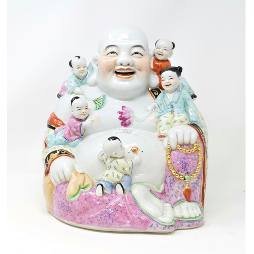 323 - A large Chinese porcelain figure of a laughing Buddha seated with children climbing on him, height 3... 