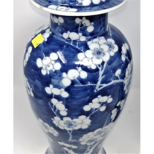 325A - Two Chinese blue and white prunis blossom lidded baluster vases (some restoration) height 39cm