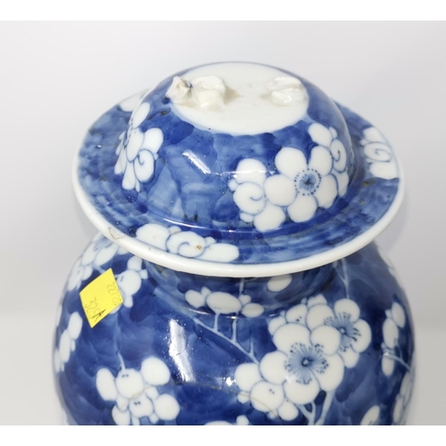 325A - Two Chinese blue and white prunis blossom lidded baluster vases (some restoration) height 39cm